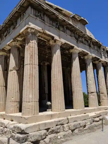 Front view of the Temple of Hephaestus showing the pronaos entrance with Doric columns rising from the crepidoma platform